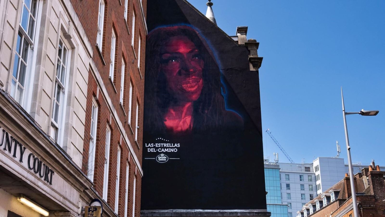 Las Estrellas del Camino street art, Heather Small painted in neon on black background